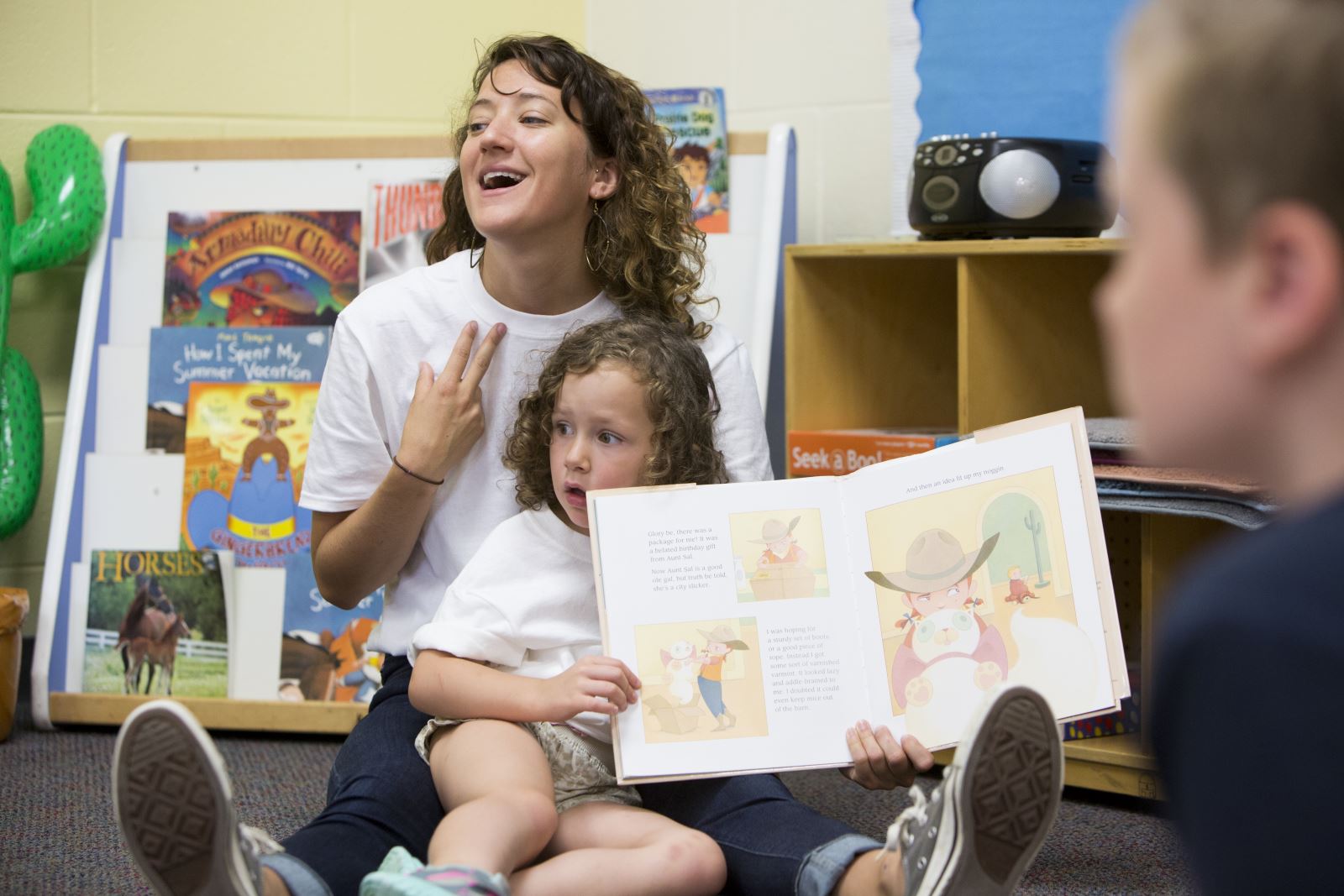 Child and therapist reading a book